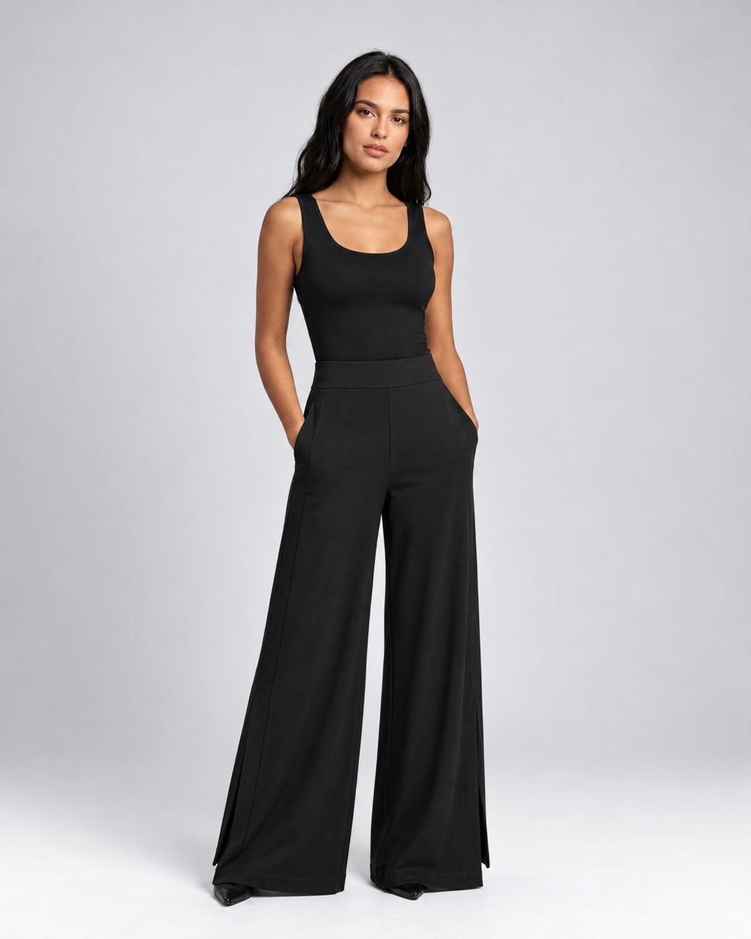 Front view of the Liberty black matte jersey wide-leg pants on a model, showing the wide waistband and side ankle vents.