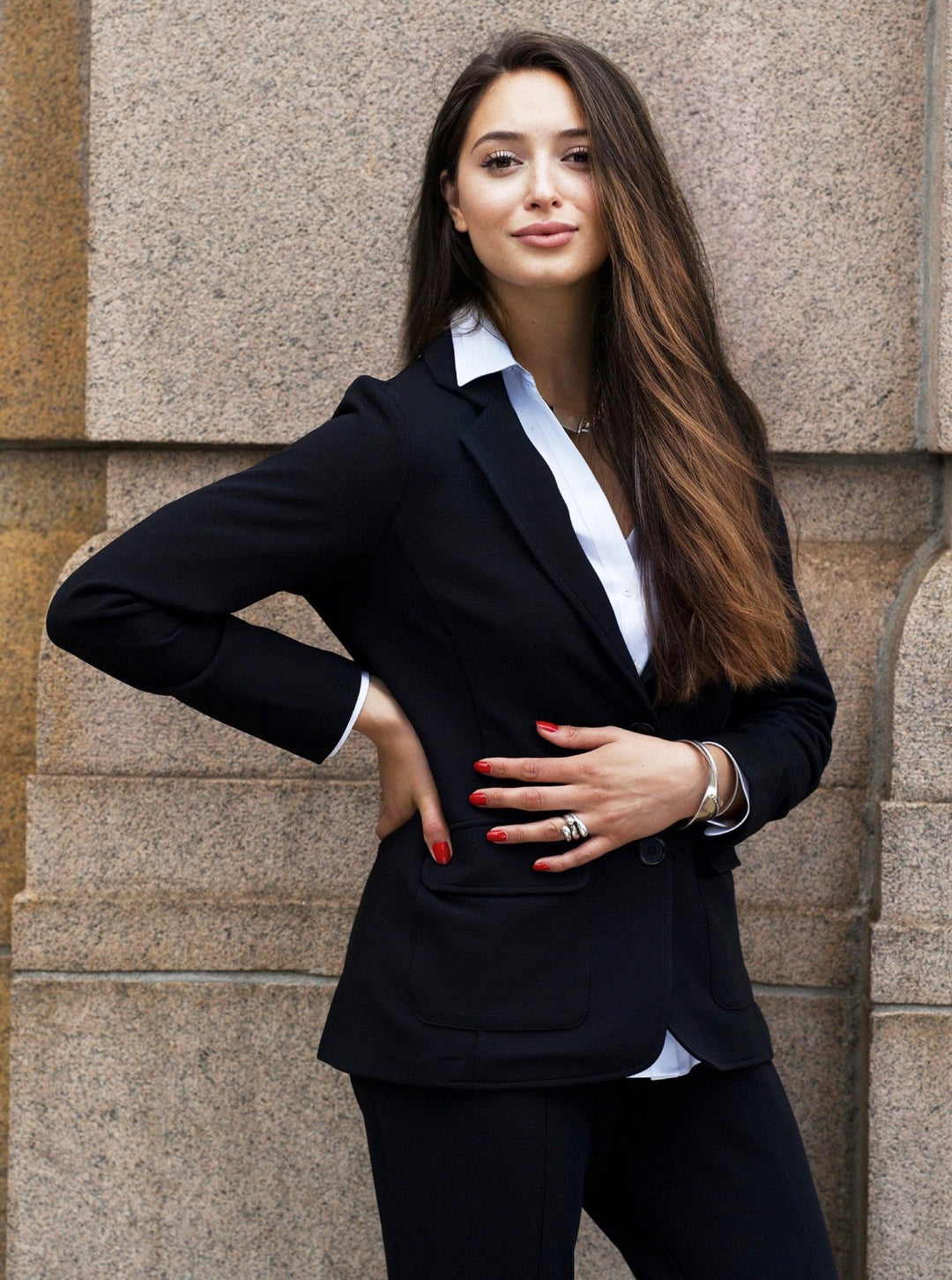 Sierra wearing the Greenwich black textured knit blazer over a white shirt