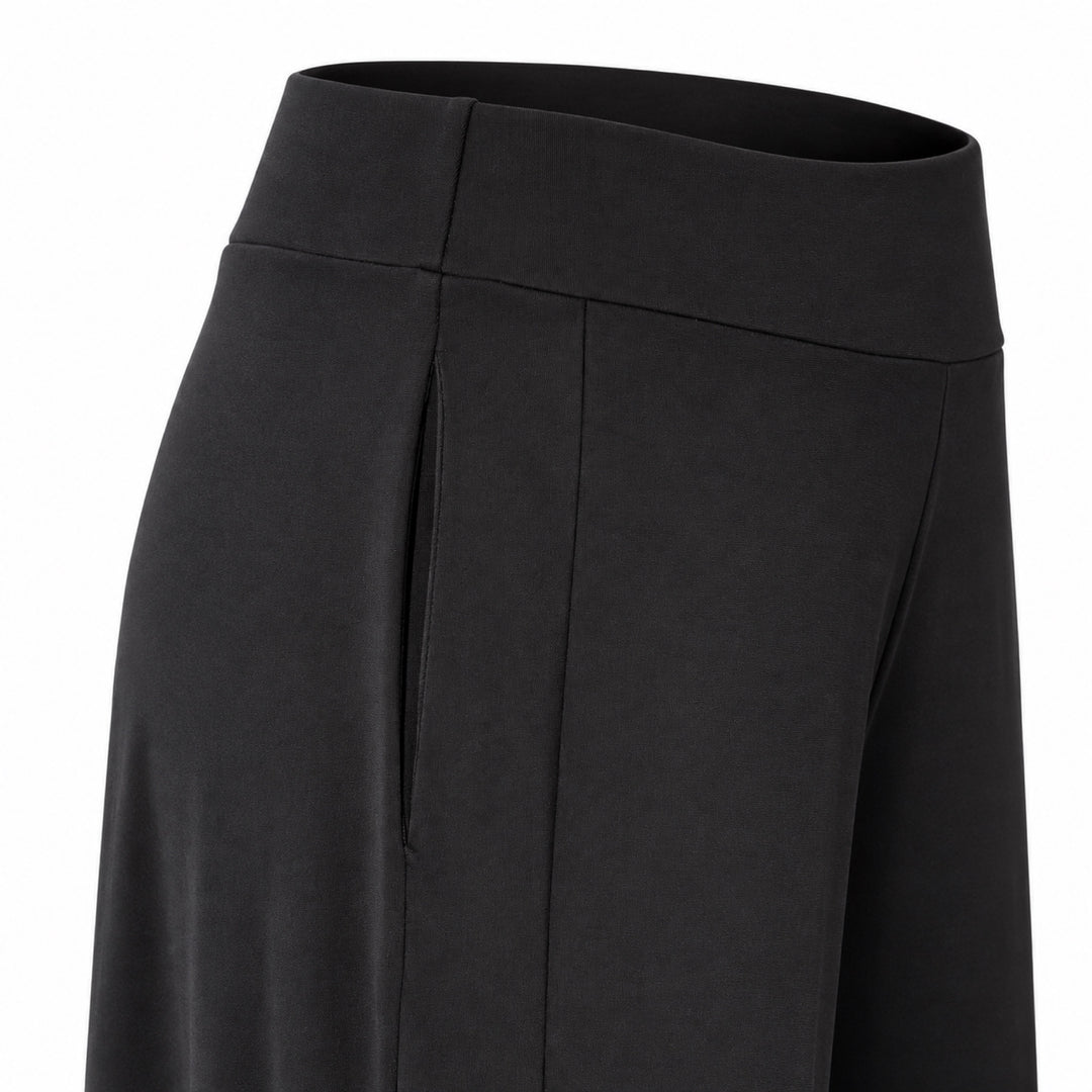 Closeup of the Liberty black matte jersey pants showing the concealed side pocket, wide waistband and side panel.