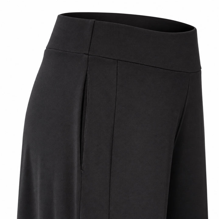 Closeup of the Liberty black matte jersey pants showing the concealed side pocket, wide waistband and side panel.