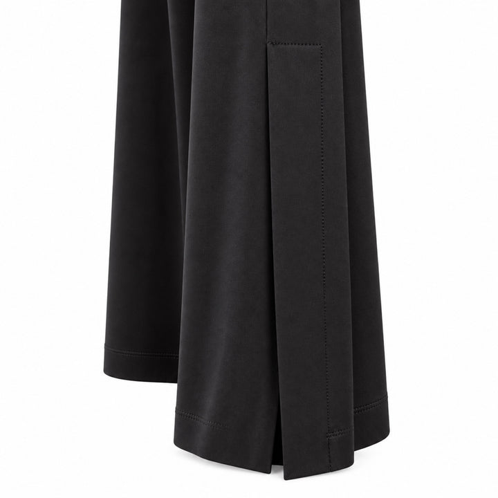 Closeup of the Liberty black matte jersey pants showing the lower side panel and overlapping ankle vent.