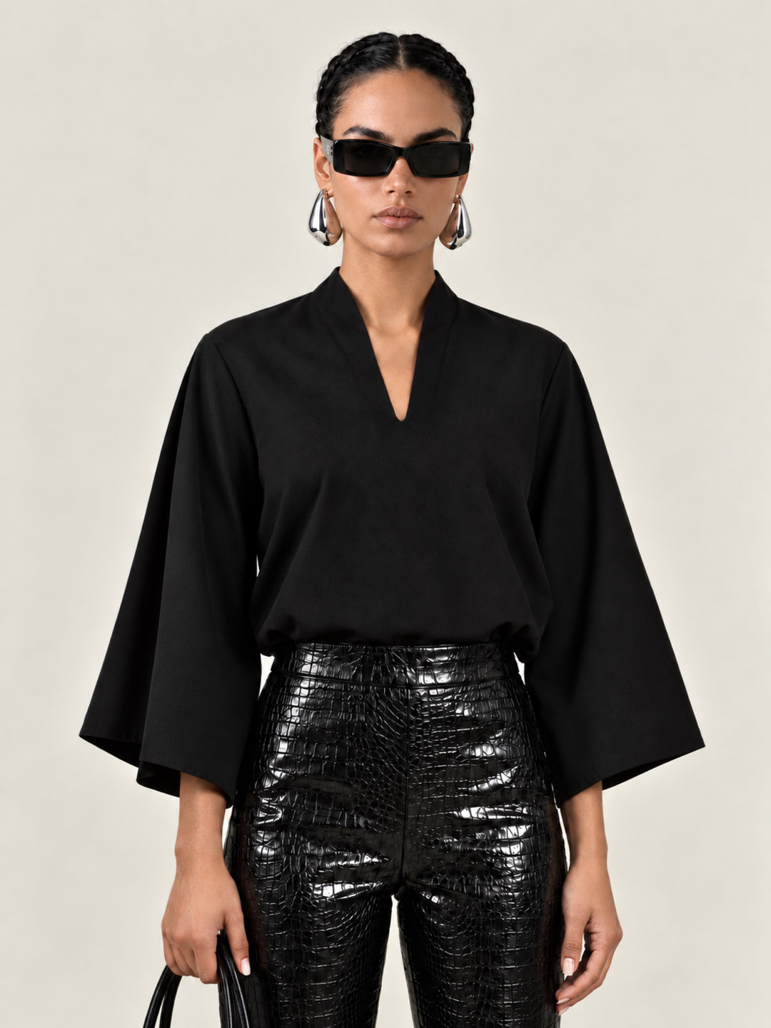 Black Waverly top, close-up front view of neckline and butterfly sleeves