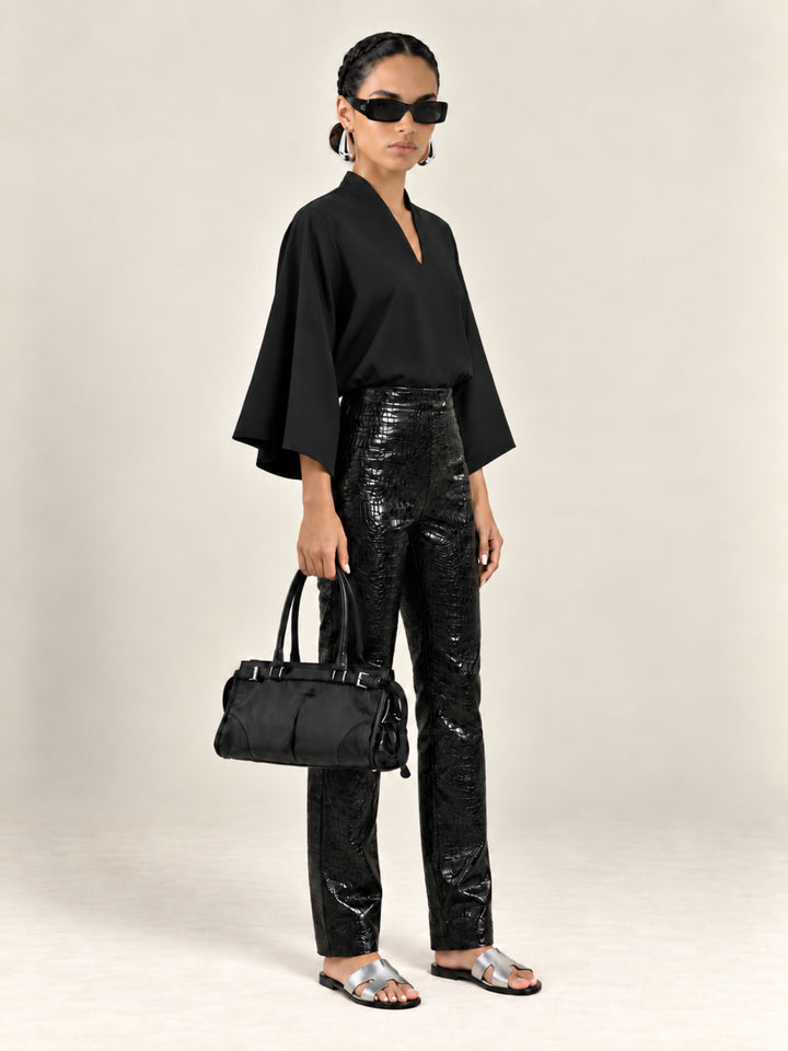 Black Waverly flutter-sleeve top with Bleeker croc pants, three-quarter view