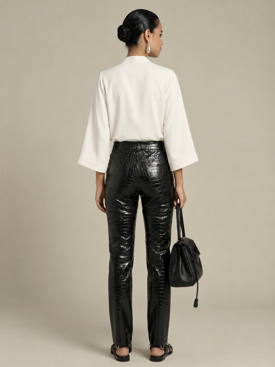 Back view of the Pearl Waverly flutter sleeve top styled with black croc embossed pants.