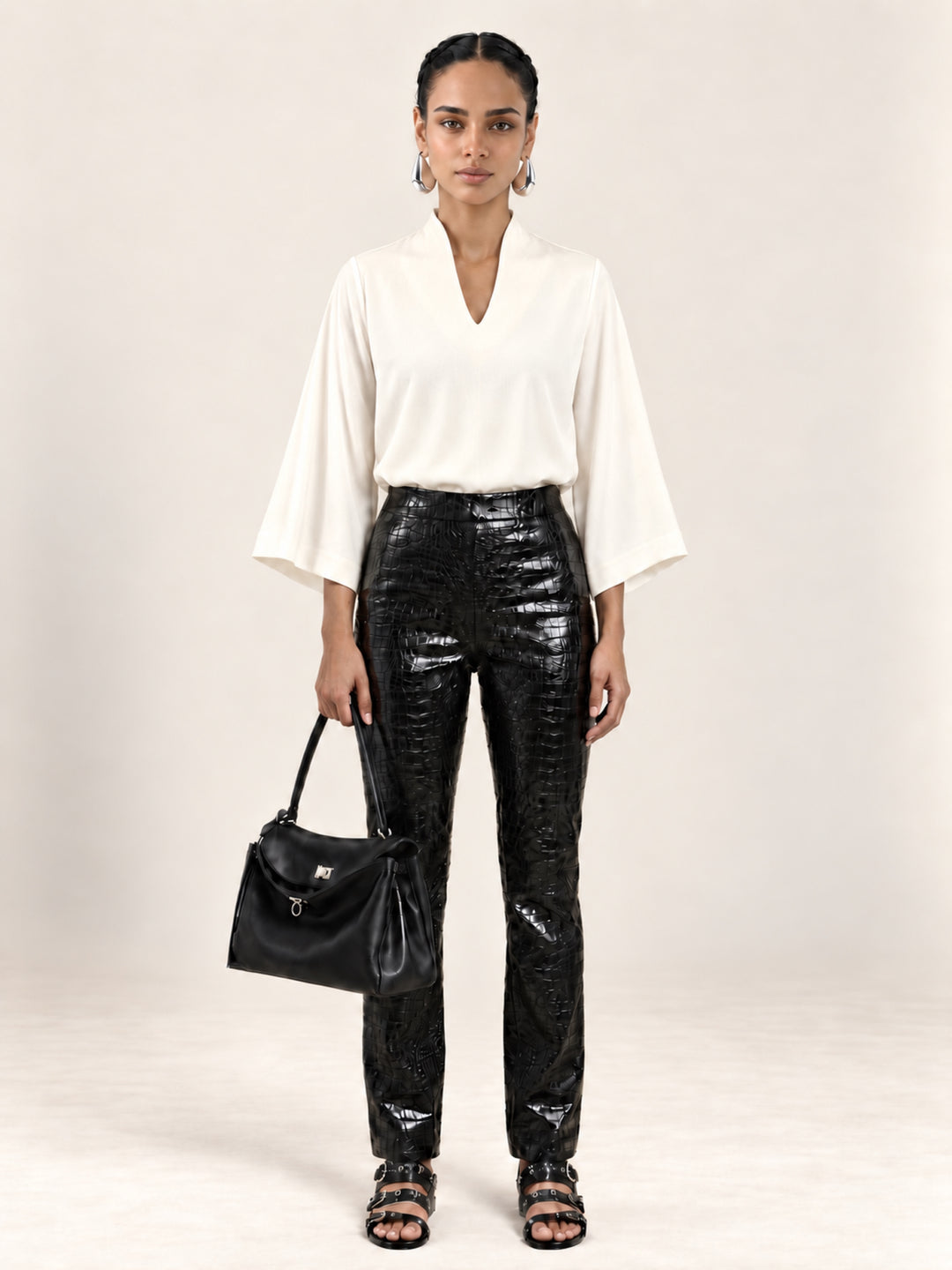 Front view of the Pearl Waverly flutter sleeve top styled with black croc embossed pants.