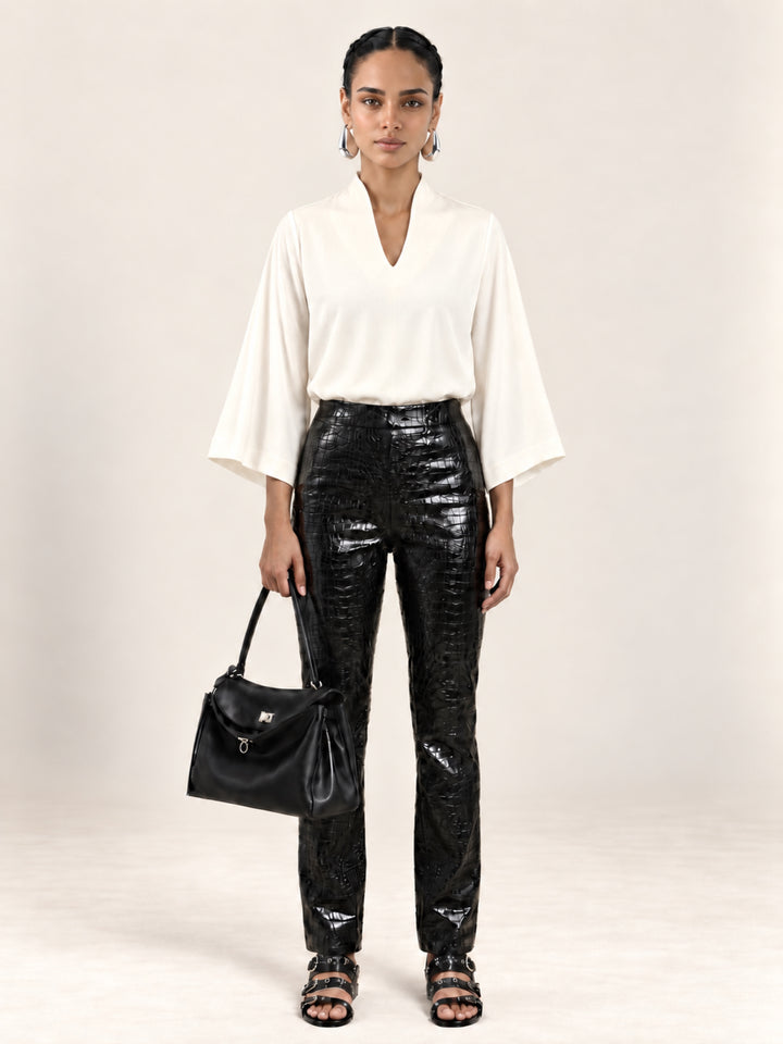Front view of the Pearl Waverly flutter sleeve top styled with black croc embossed pants.