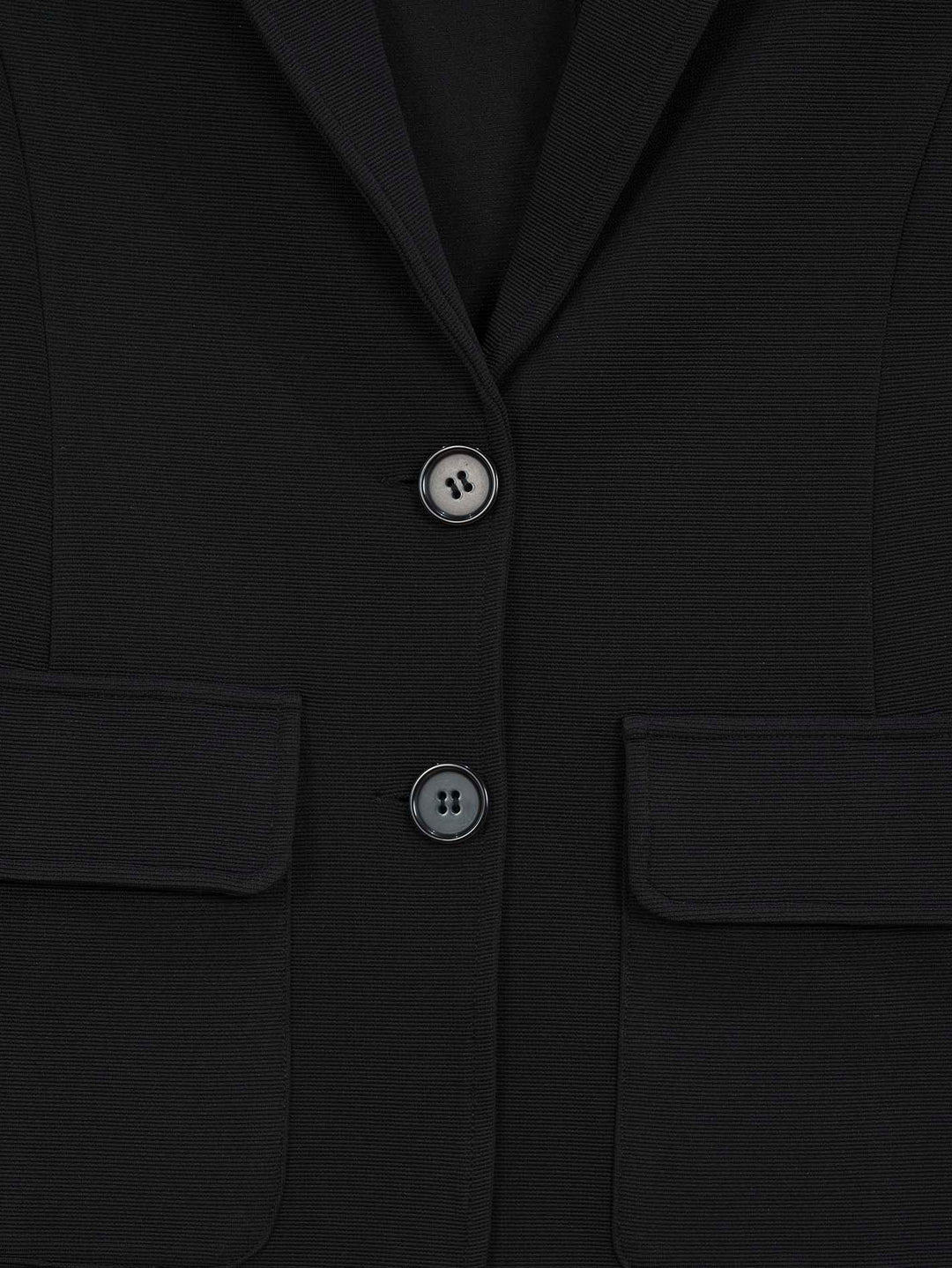 Close-up of buttons  and pockets. 